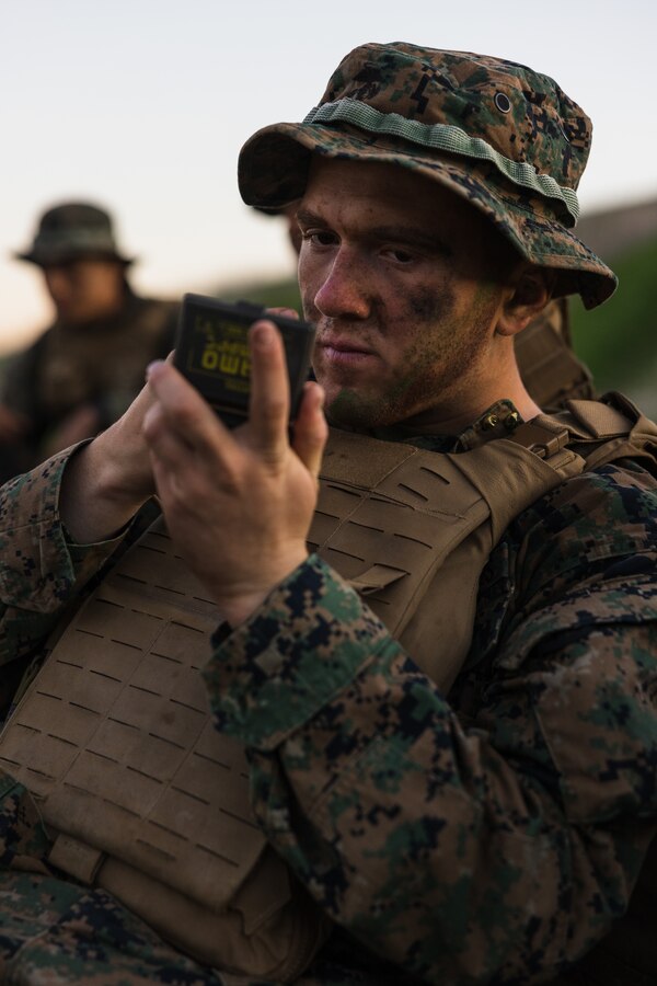 U.S. Marine, Pfc. Ethan Degooyer, a rifleman with Infantry Marine Course 1-23, Infantry Training Battalion, School of Infantry - West, reapplies camouflage paint during the course’s final training exercise on Marine Corps Base Camp Pendleton, California, Jan. 27, 2023. IMC is the Marine Corps’ 14-week entry-level training course for enlisted infantry Marines. Degooyer is a native of Salt Lake City. (U.S. Marine Corps photo by Lance Cpl. Earik Barton)