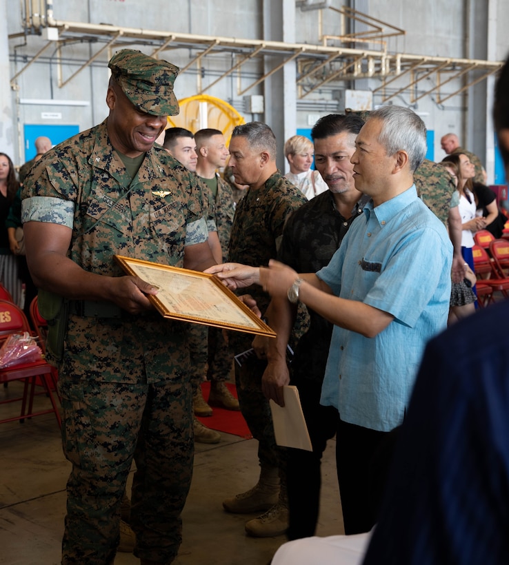 U.S. Marine Corps Col. Henry Dolberry Jr. receives a gift after a change of command ceremony on Marine Corps Air Station Futenma, Okinawa, Japan, May 8, 2023. Dolberry relinquishes command to Col. Willam C. Pacatte. Pacatte is coming from 1st Marine Aircraft Wing, where he was the Assistant Chief of Staff with G-3 operations. (U.S. Marine Corps photo by Cpl. Jessica Massi)