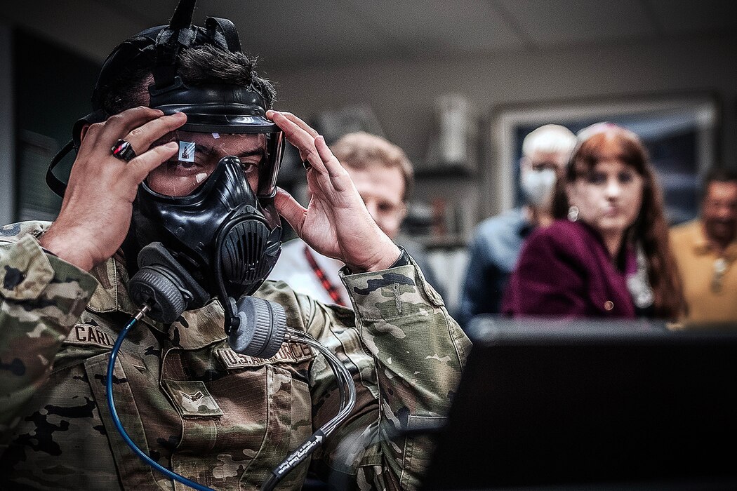 Photo of an Airman testing a gas mask