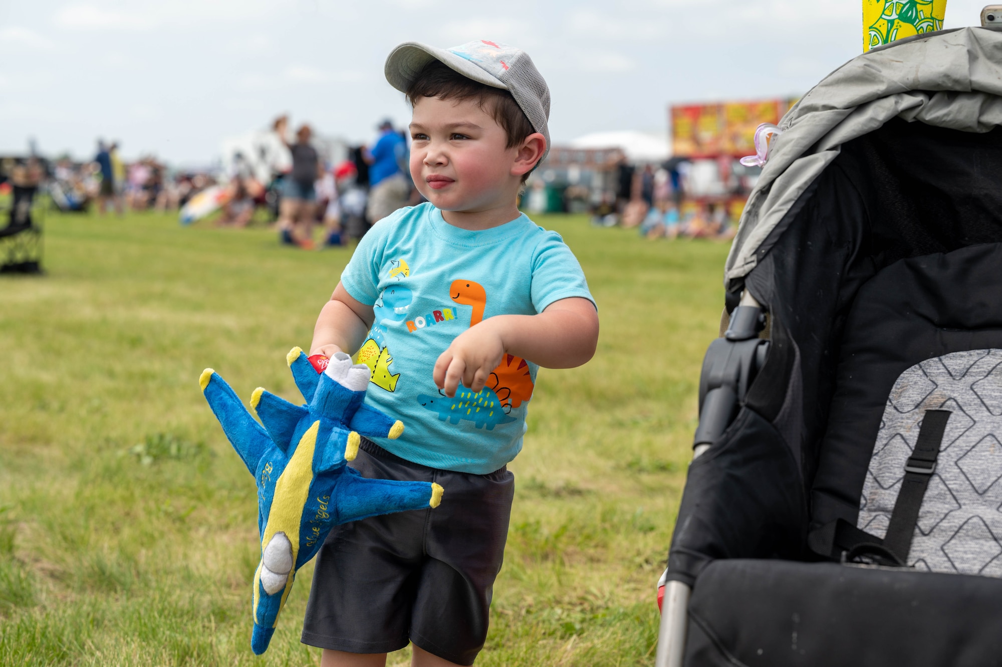 Young boy holds toy plane.