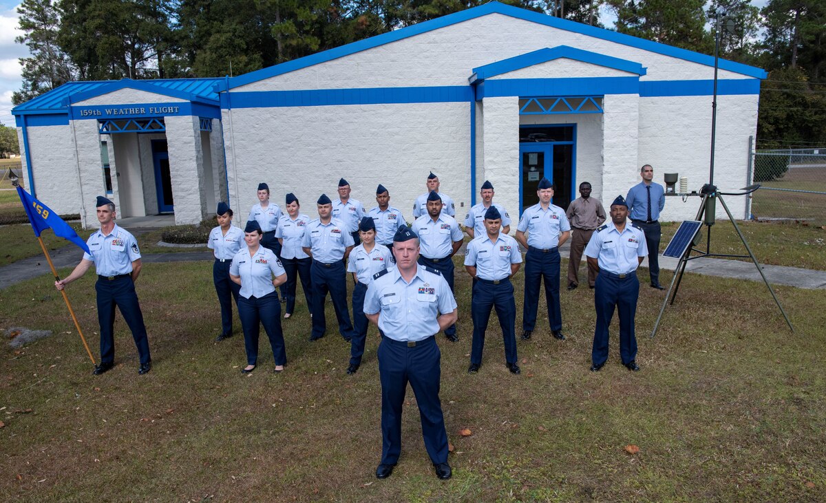 U.S. Air Force Airmen assigned to the 159th Weather Flight, Florida Air National Guard, pose for a group photo outside the unit's headquarters on Camp Blanding Joint Training Center, Florida in 2021. The159th WF was named the 2022 Outstanding ANG AWS Weather Flight of the Year. (U.S. Air National Guard photo by Staff Sgt. Cole Benjamin)