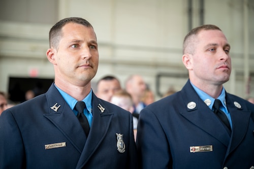 Capt. Greg Arnold and Firefighter Jeffrey Hoffman stand at attention.