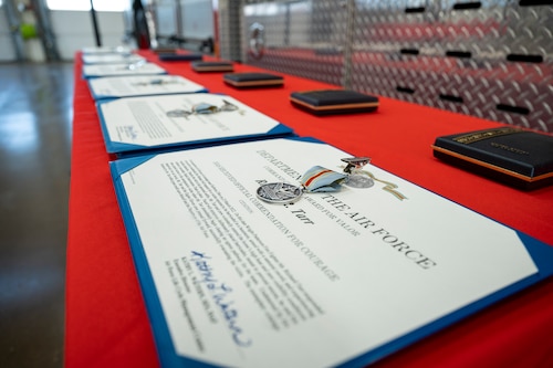 Medals and citations sit on a table.