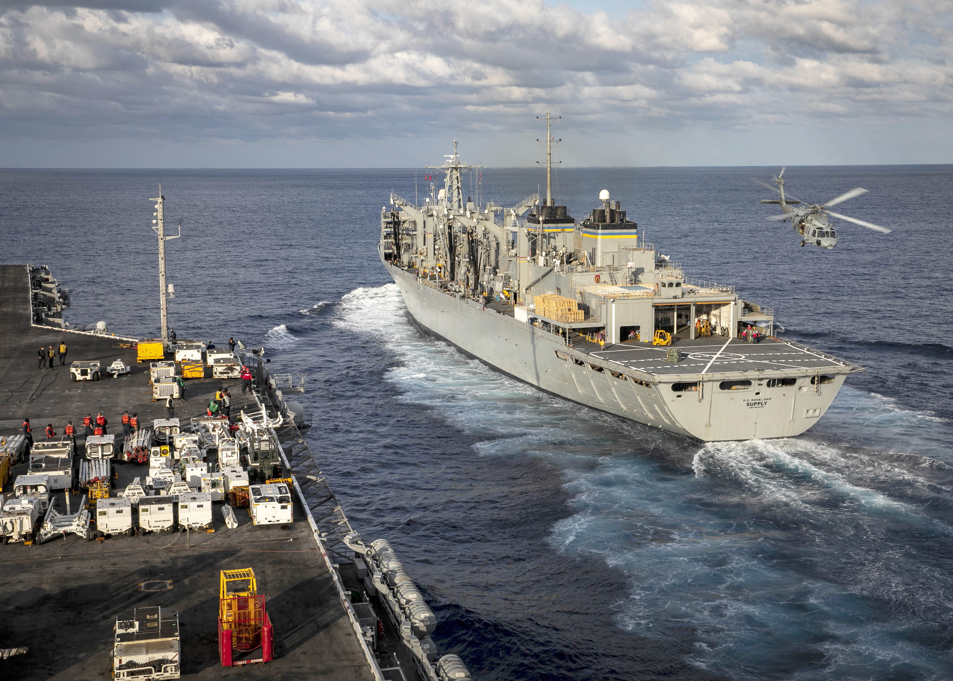 USS George H.W. Bush (CVN 77), left, approaches USNS Supply (T-AOE 6) for an ordnance offload in the Atlantic Ocean.