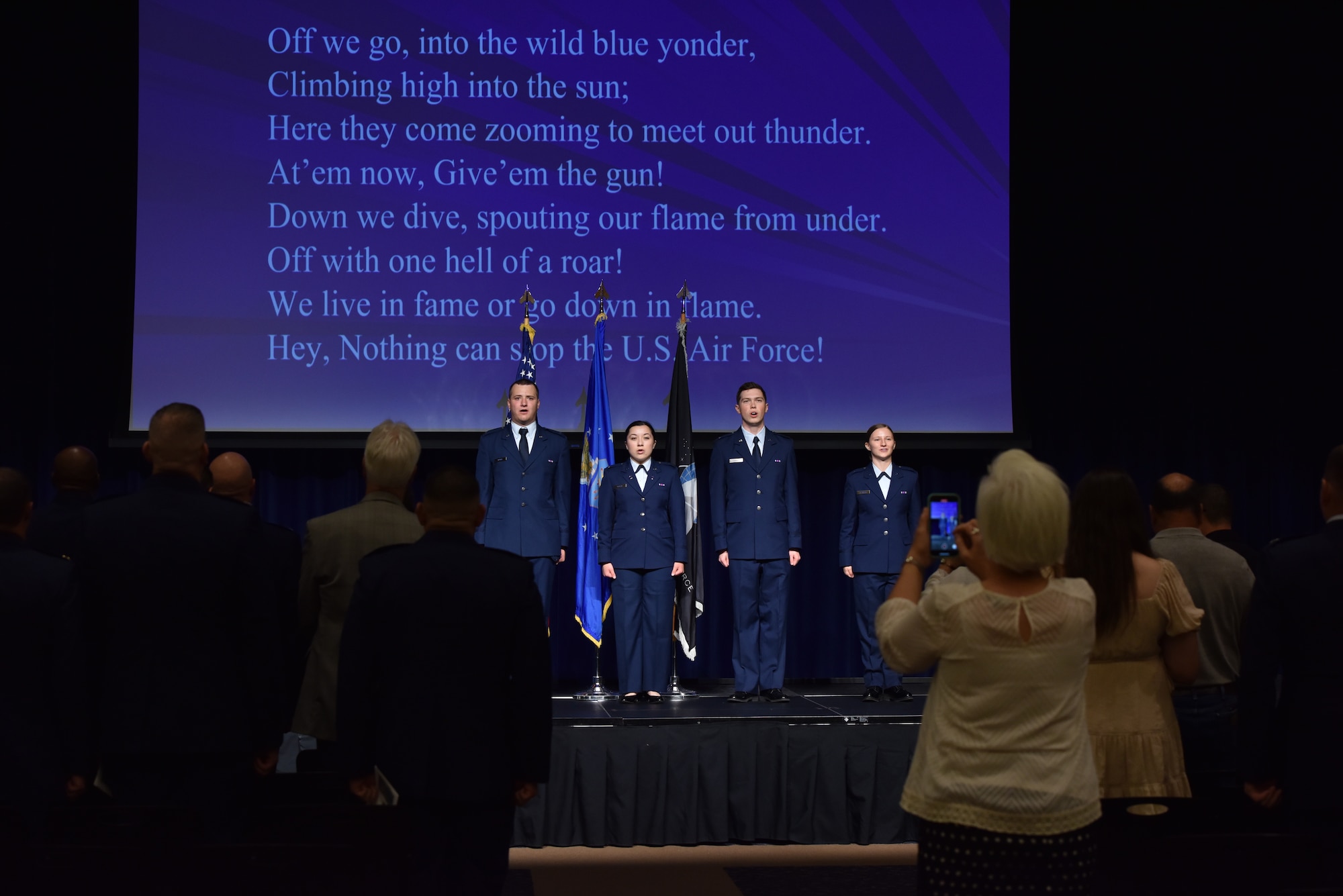 Newly commissioned U.S. Air Force and Space Force officers sing the Air Force song at Angelo State University, San Angelo, Texas, May 12, 2023. The new officers closed the ceremony by leading the crowd in song. (U.S. Air Force photo by Airman 1st Class Madison Collier)