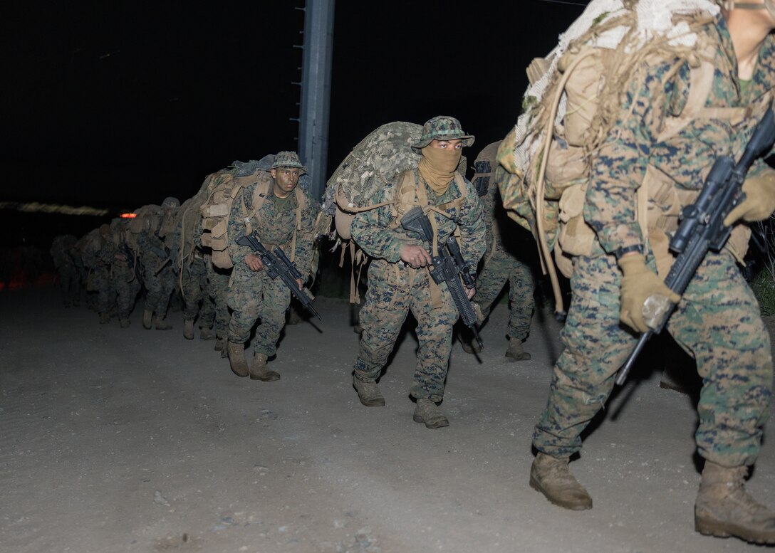 U.S. Marines with Infantry Marine Course 1-23, Infantry Training Battalion, School of Infantry - West, step out for the culminating event of the course’s final training exercise on Marine Corps Base Camp Pendleton, California, Jan. 27, 2023. IMC is the Marine Corps’ 14-week entry-level training course for enlisted infantry Marines. (U.S. Marine Corps photo by Lance Cpl. Earik Barton)