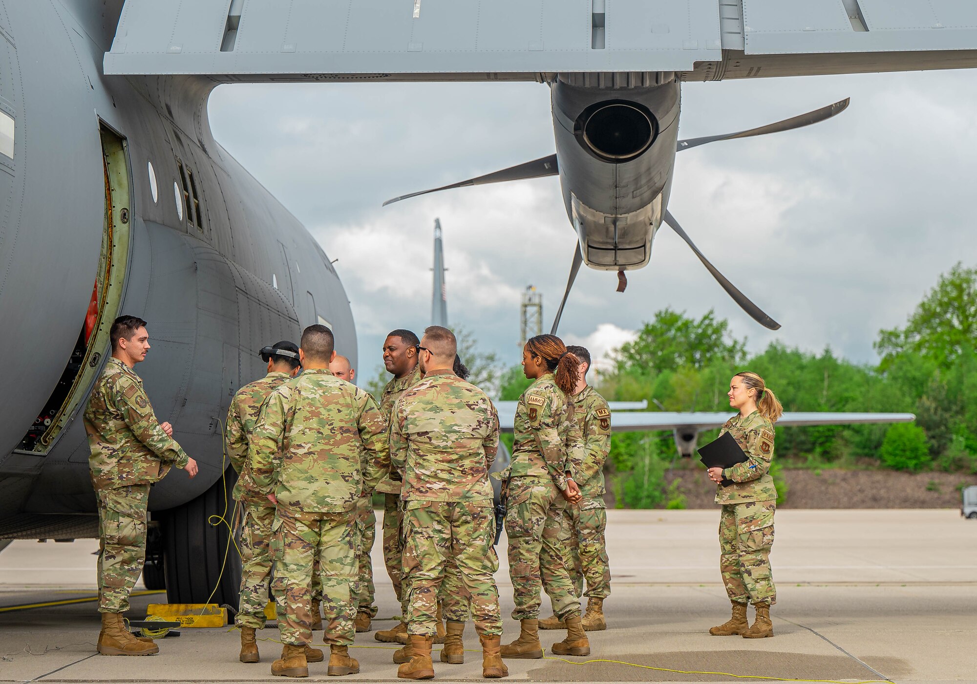 U.S. Air Force members from the 86th Logistics Readiness Squadron and the 86th Aircraft Maintenance Squadron gather for a safety brief before demonstrating the refueling process of a C-130J Super Hercules aircraft at Ramstein Air Base, Germany, May 11, 2023. They conducted an immersion tour with the 86th Airlift Wing command team to provide a closer look at the achievements and challenges of the 86th LRS fuels team.