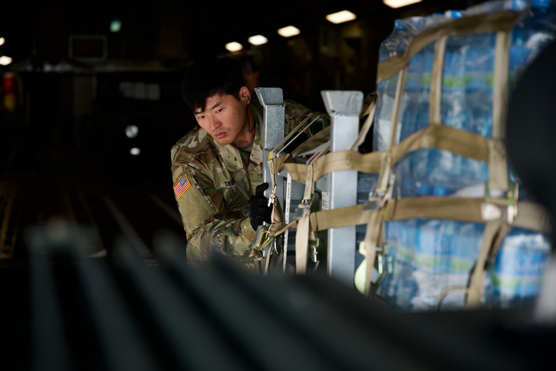 A soldier pushes a pallet.