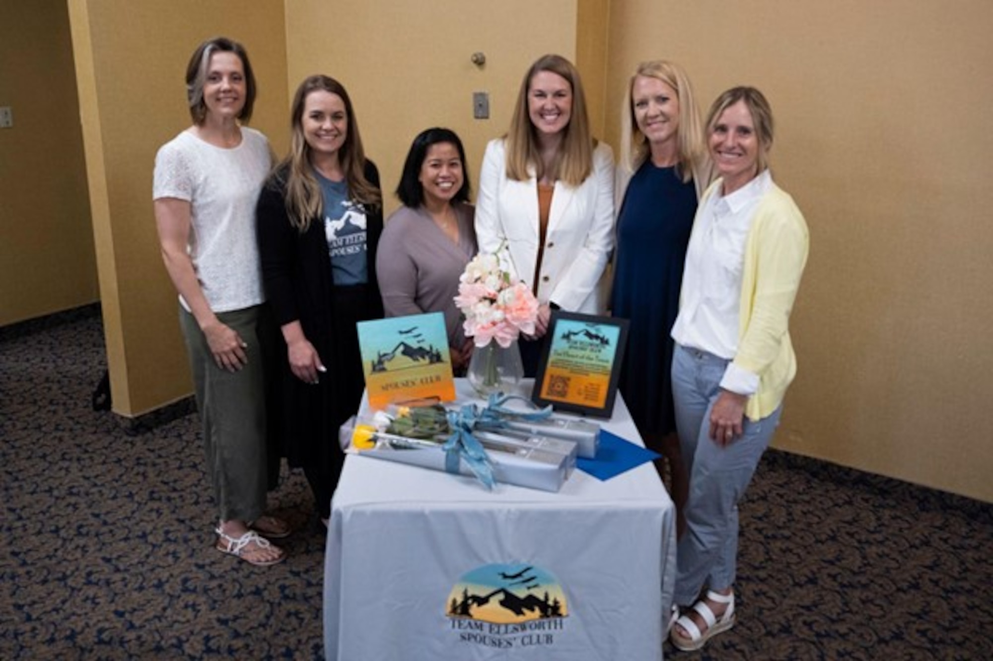 Members from the Team Ellsworth Spouse Club board pose for a photo before presenting their yearly scholarship to three spouses at Ellsworth Air Force Base, S.D., May 11, 2023. A banquet was held to present and celebrate the scholarship recipients and talk about their future educational endeavors. (U.S. Air Force photo by Airman 1st Class Josephine Pepin)