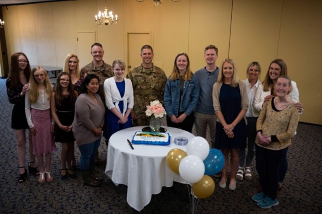 A group of U.S. Air Force Airmen and their dependents pose for a photo at Team Ellsworth Spouse Club’s scholarship banquet at Ellsworth Air Force Base, S.D., May 11, 2023. The banquet celebrated and presented scholarships to three dependents associated with the base. (U.S. Air Force photo by Airman 1st Class Josephine Pepin)