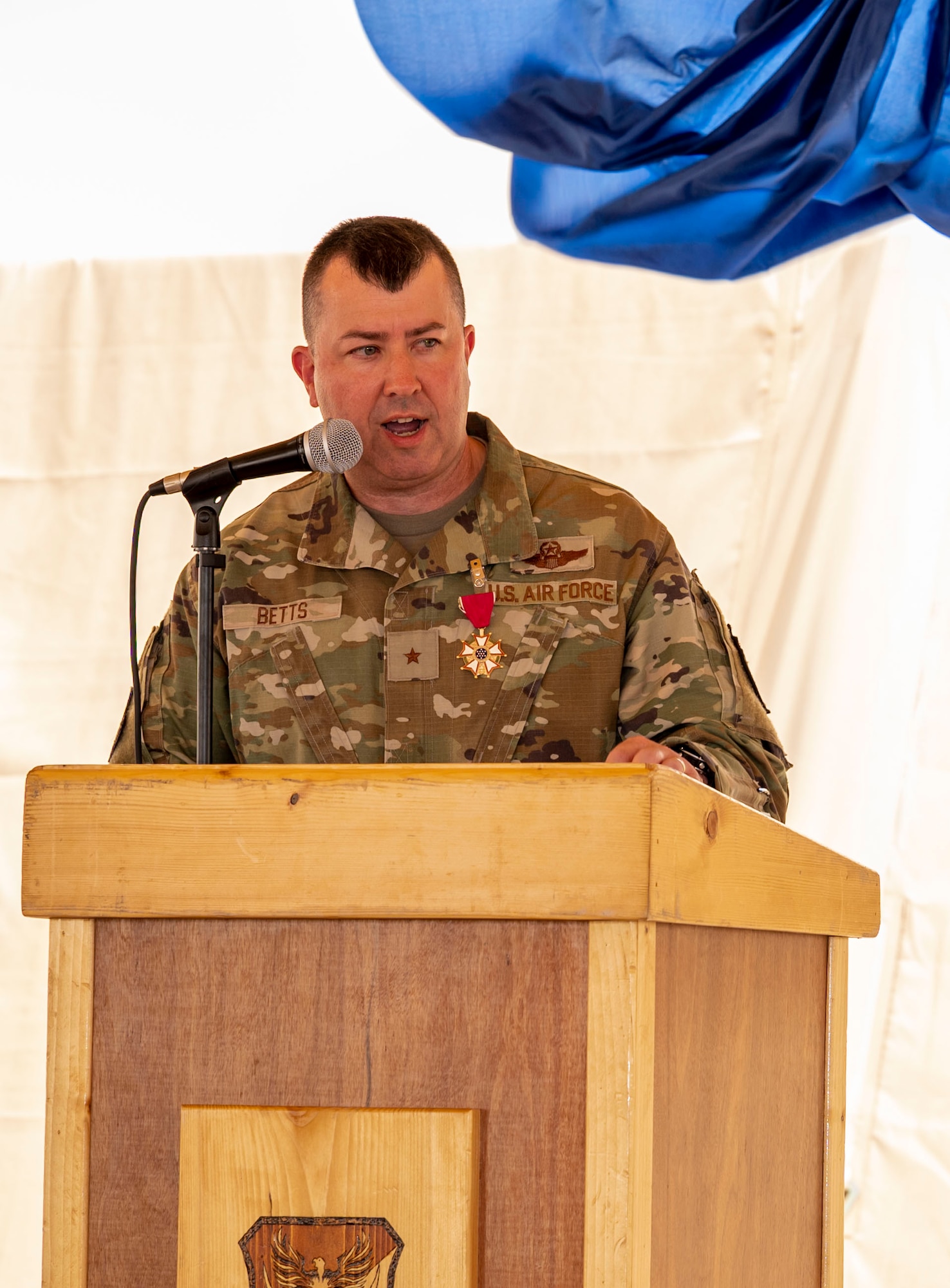 U.S. Air Force Brig. Gen. William Betts, outgoing commander of the 378th Air Expeditionary Wing, speaks during a change of command ceremony at Prince Sultan Air Base, Kingdom of Saudi Arabia, May 18, 2023. During the ceremony, Betts relinquished command of the 378th AEW to Brig. Gen. Akshai Gandhi. The tradition of change of command ceremonies are to allow service members to witness their new leader assume the responsibility and trust associated with the position of commander. (U.S. Air Force photo by Senior Airman Stephani Barge)