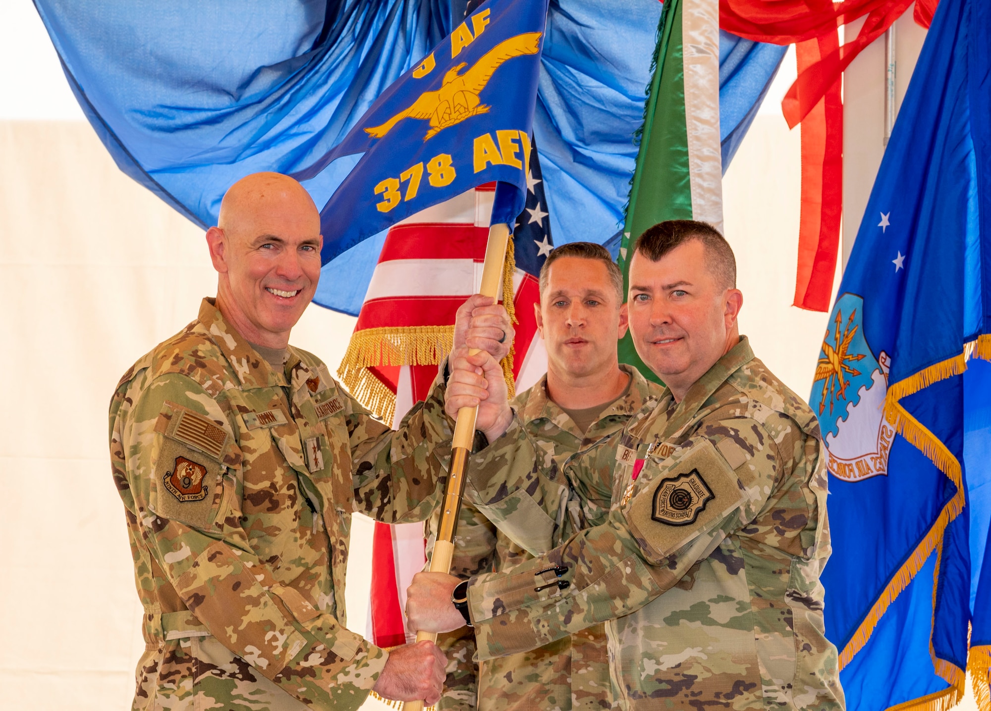 U.S. Air Force Brig. Gen. William Betts, right, outgoing commander of the 378th Air Expeditionary Wing, relinquishes command to Maj. Gen. Clark Quinn, left, Ninth Air Force deputy commander, during a change of command ceremony at Prince Sultan Air Base, Kingdom of Saudi Arabia, May 18, 2023. During the ceremony, Betts relinquished command of the 378th AEW to Brig. Gen. Akshai Gandhi. The tradition of change of command ceremonies are to allow service members to witness their new leader assume the responsibility and trust associated with the position of commander. (U.S. Air Force photo by Senior Airman Stephani Barge)