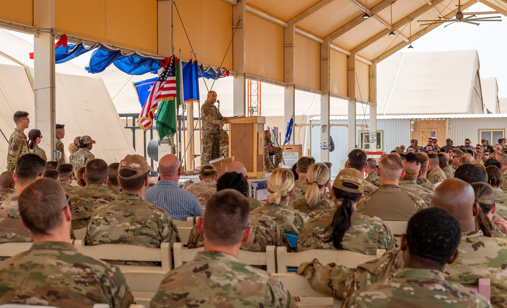U.S. Air Force Brig. Gen. Akshai Gandhi, incoming commander of the 378th Air Expeditionary Wing, speaks during a change of command ceremony at Prince Sultan Air Base, Kingdom of Saudi Arabia, May 18, 2023. During the ceremony, Brig. Gen. William Betts relinquished command of the 378th AEW to Gandhi. The tradition of change of command ceremonies are to allow service members to witness their new leader assume the responsibility and trust associated with the position of commander. (U.S. Air Force photo by Senior Airman Stephani Barge)