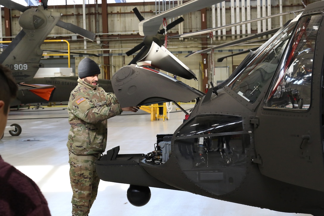 U.S. Army Warrant Officer Dejour Hughes, a helicopter pilot with the Pennsylvania National Guard, prepares a UH-60 Black Hawk helicopter for flight in the Army Aviation Support Facility at Muir Army Airfield, Feb. 1, 2023. (U.S. Army National Guard photo by Capt. Travis Mueller)