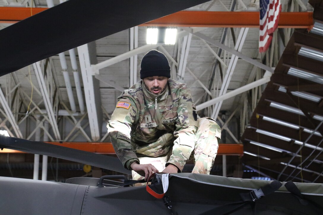 U.S. Army Warrant Officer Dejour Hughes, a helicopter pilot with the Pennsylvania National Guard, prepares a UH-60 Black Hawk helicopter for flight in the Army Aviation Support Facility at Muir Army Airfield, Feb. 1, 2023. (U.S. Army National Guard photo by Capt. Travis Mueller)