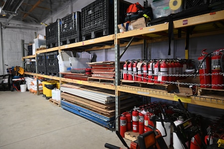 Photo of equipment organized on shelves in a storage room.