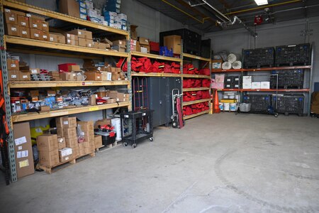 Photo of equipment organized on shelves in a storage room.