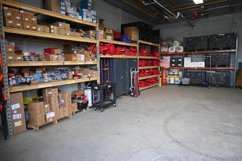 Photo of equipment organized on shelves in a storage room.