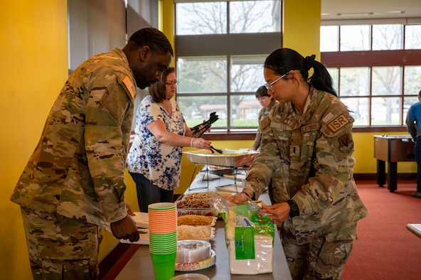 members prepare a spread of food to be shared.