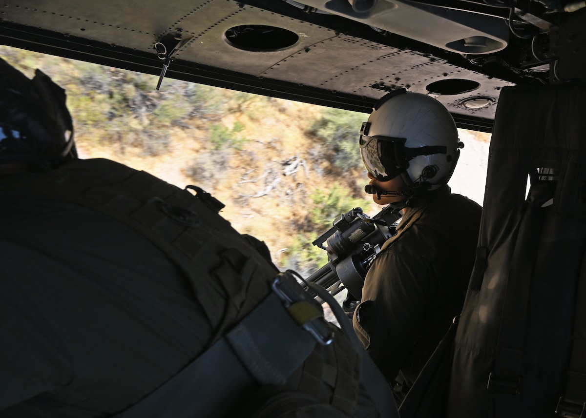 U.S. Marine Corps Lance Cpl. Rei Kitamura, Marine Light Attack Helicopter Squadron 775 crew chief, searches for simulated opposition forces on the ground during Exercise RED FLAG- Rescue 23-1 throughout Arizona and New Mexico, May 13, 2023. Kitamura provided extra situational awareness for the UH-1Y Venom utility helicopter pilots. (U.S. Air Force photo by Staff Sgt. Abbey Rieves)