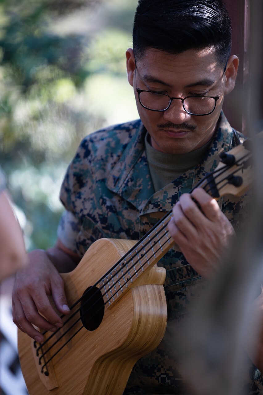 A Marine plays the guitar.