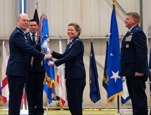 Col. Amy Bumgarner assumes command as the 20th Office of Special Investigations commander during the change of command ceremony on May 16, 2023, at Joint Base Andrews, Maryland, presided over by Lt. Gen. Stephen L. Davis, left, the Inspector General of the Department of the Air Force. Bumgarner succeeded Brig. Gen. Terry Bullard, right, as OSI commander. (U.S. Air Force Photo by Thomas Brading, OSI/PA)