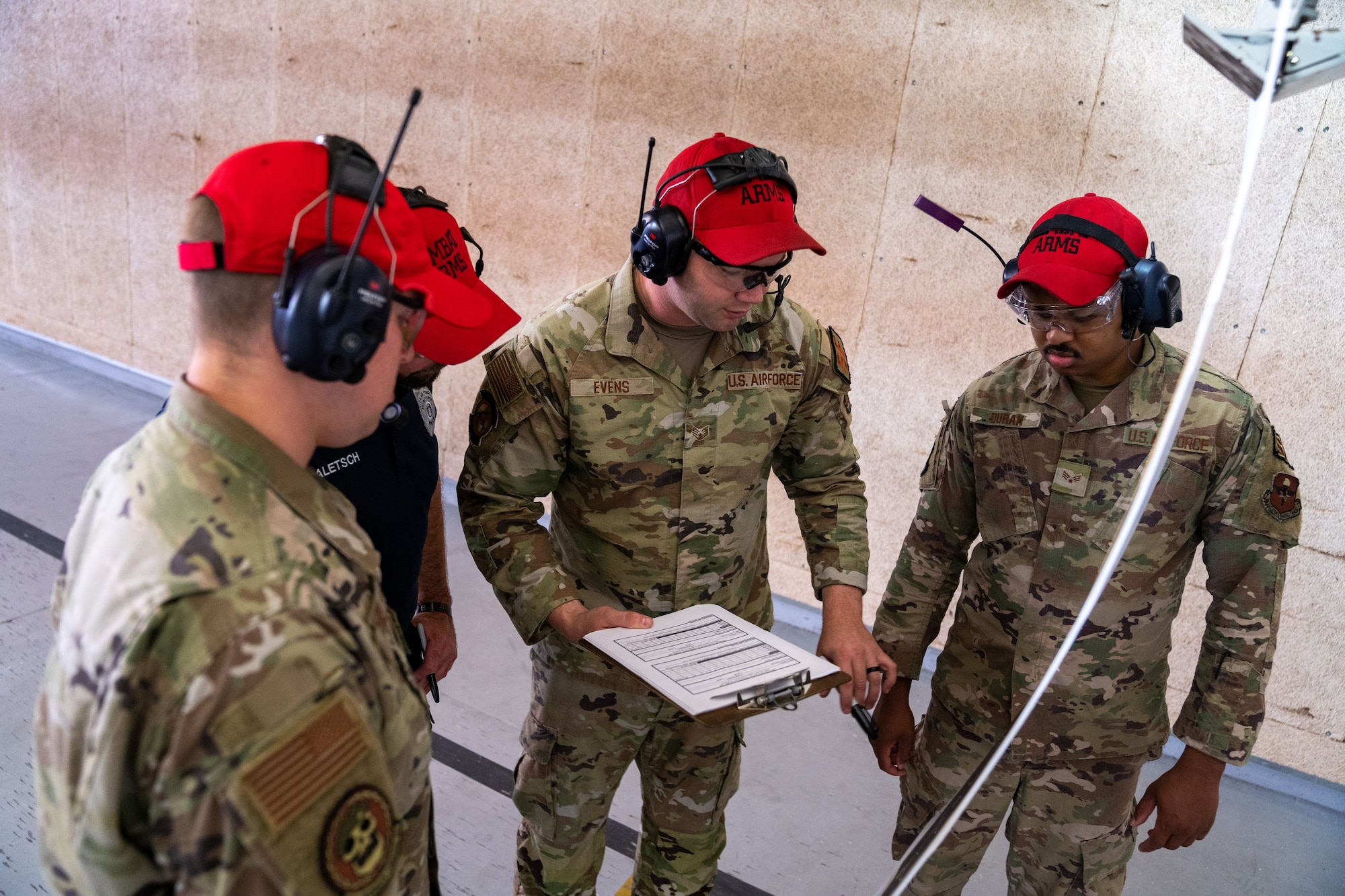 Combat arms instructors from 81st Security Forces Squadron review and score a target during the National Police Week pistol competition at Keesler Air Force Base, Mississippi, May 17, 2023.