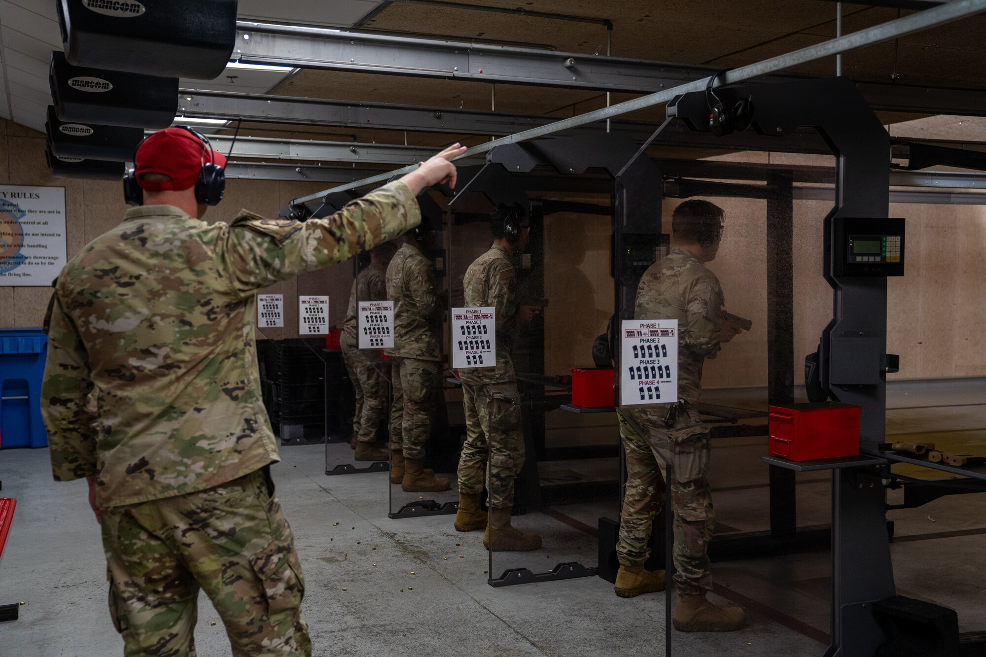 U.S. Air Force Staff Sgt. David Evens, 81st Security Forces Squadron combat arms instructor, signals that the line is ready to fire during the National Police Week pistol competition at Keesler Air Force Base, Mississippi, May 17, 2023.