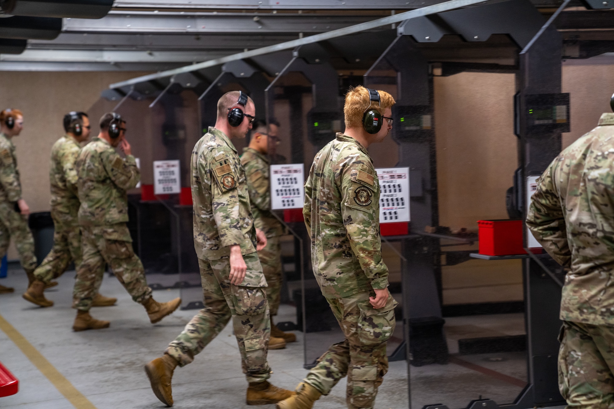 Airmen approach the firing line for a pistol competition during National Police Week at Keesler Air Force Base, Mississippi, May 17, 2023.