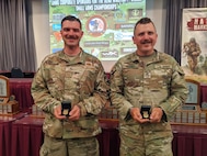 Two NHNG shooters, Tech. Sgt. Connor Cunio of the 157th Air Refueling Wing and Sgt. 1st Class David Musso of 3643d Brigade Support Battalion show off their “Chief’s 50” badges May 5, 2023, at the 52nd Annual Winston P. Wilson Rifle and Pistol Championships awards ceremony in North Little Rock, Arkansas.