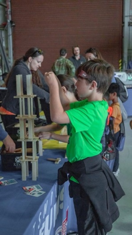 Child constructs tower.