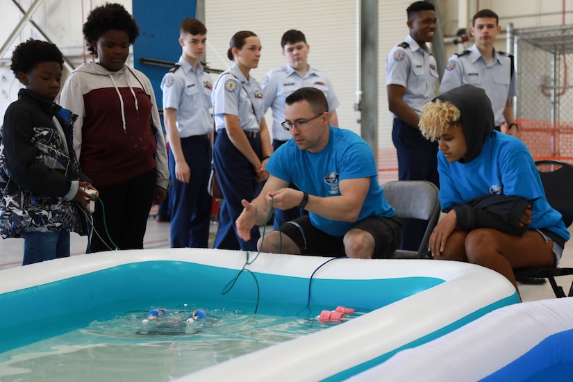 Child uses aquatic robots.