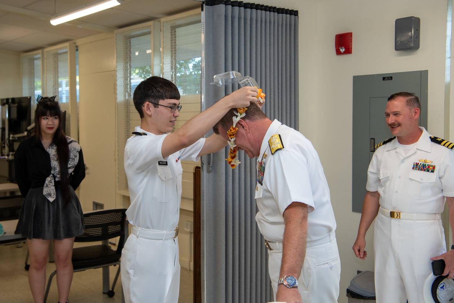 Midshipman 3rd Class Robert Nelson, from Makakilo, Hawaii, a student in the University of Hawaii’s Naval ROTC program, presents Adm. Samuel Paparo, commander, U.S. Pacific Fleet, with a lei for his support towards the exterior renovation of the Naval ROTC facilities, April 29, 2023. The execution of the facility renovation was a collaborative effort between UH Naval ROTC, UH facilities department, Seabees assigned to Construction Battalion Maintenance Unit 303 and U.S. Pacific Fleet. (U.S. Navy photo by Chief Mass Communication Specialist Jonathan B. Trejo)