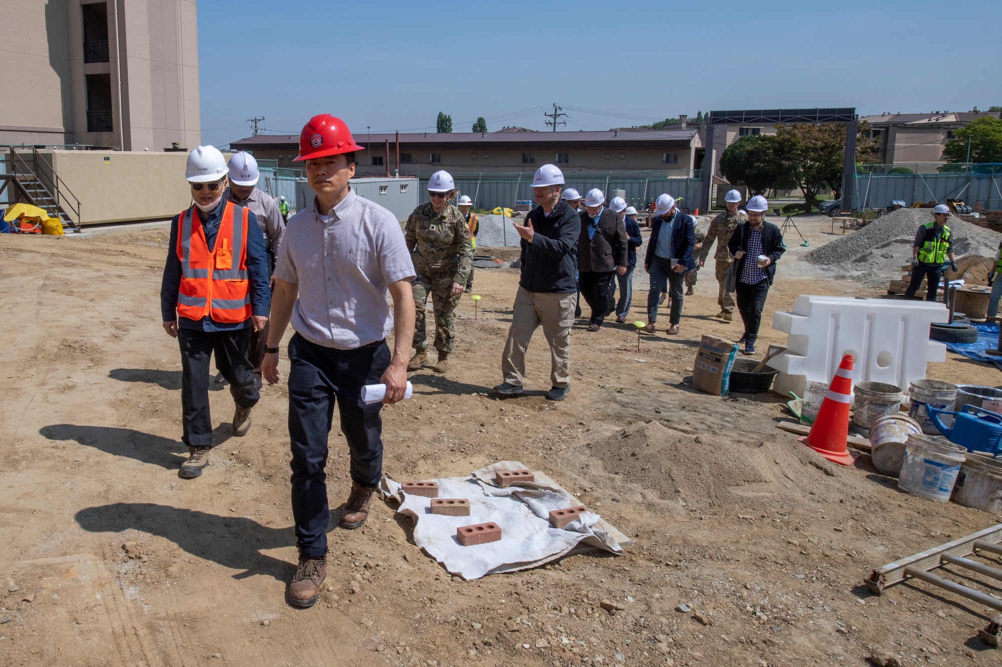 A clergy tour group walks to the chapel building at the 51st Fighter Wing chapel construction site on Osan Air Base, Republic of Korea, May 4, 2023. During the tour, local religious members were able to meet face-to-face with the chaplain team and tour the facilities on base.  (U.S. Air Force Photo by Airman 1st Class Aaron Edwards)