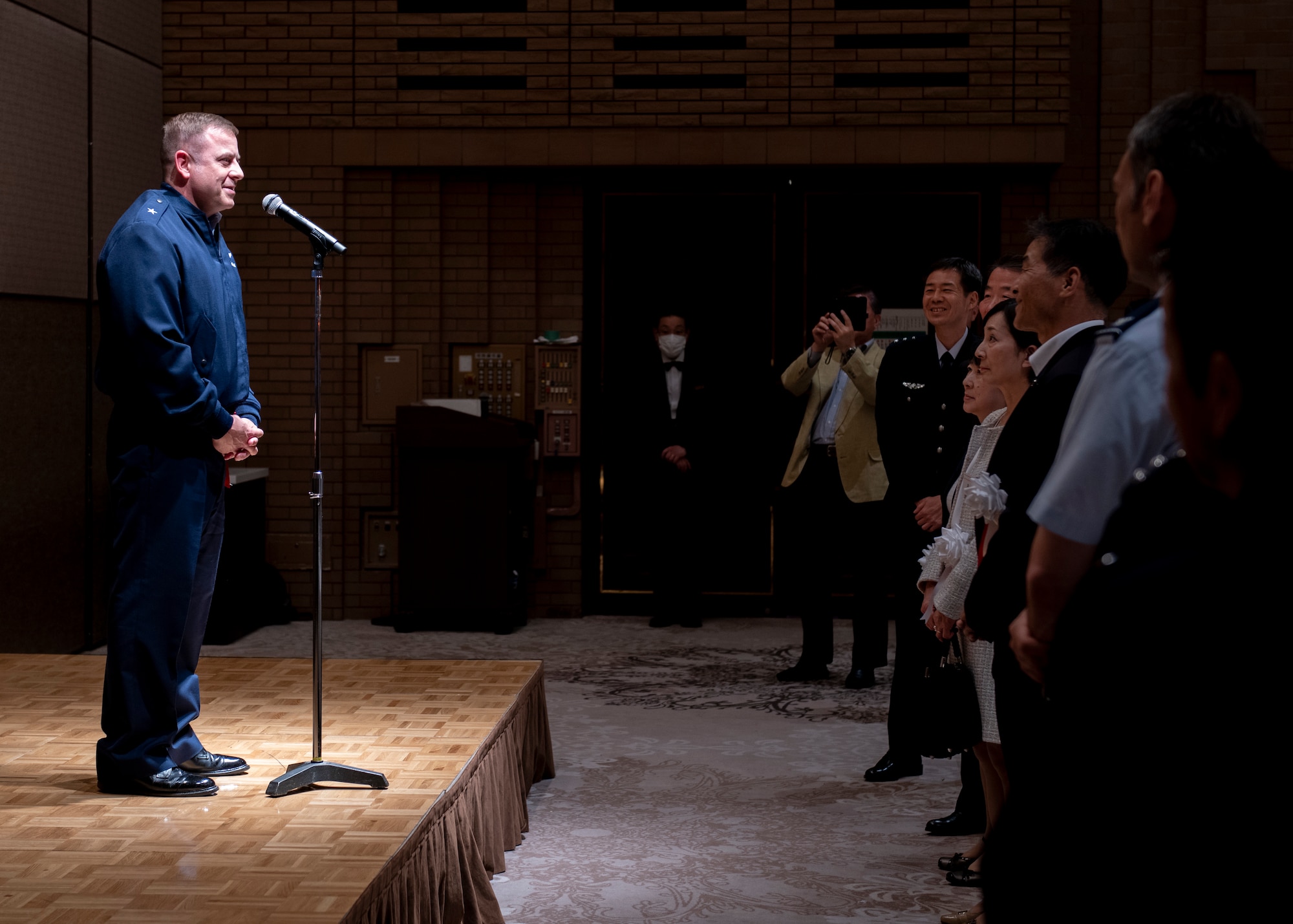 An American man stands in front of a crowd