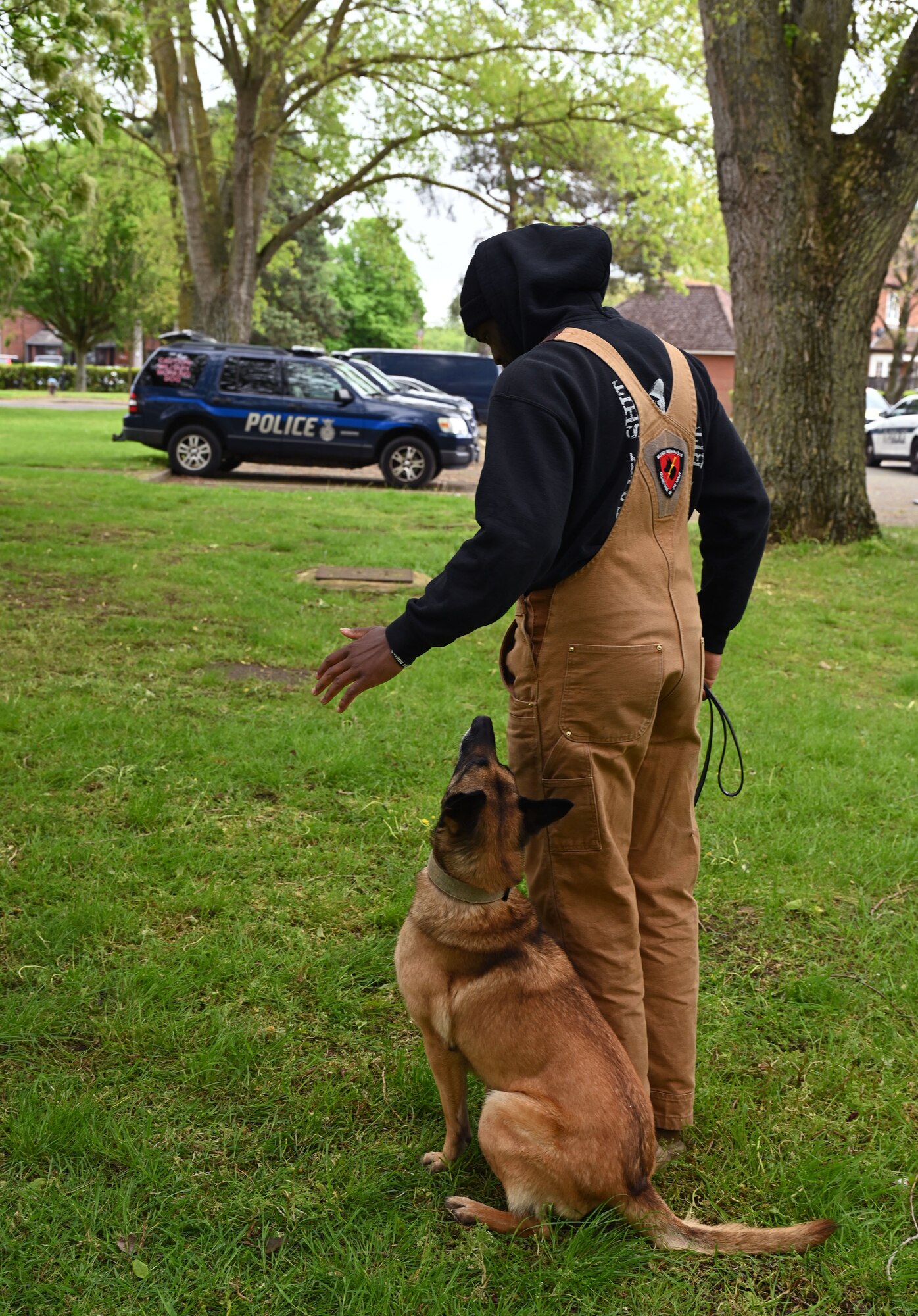 U.S. Air Force Military Working Dog Uta listens to commands from her handler, U.S. Air Force Senior Airman Jelani Bell, 100th Security Forces Squadron K9 section, during an impromptu training session at the Police Week show-and-tell event at Royal Air Force Mildenhall, England, May 15, 2023. This year’s events include a ruck march, Defenders’ Challenge, “jail and bail,” and Fallen Defender memorial. (U.S. Air Force photo by Karen Abeyasekere)