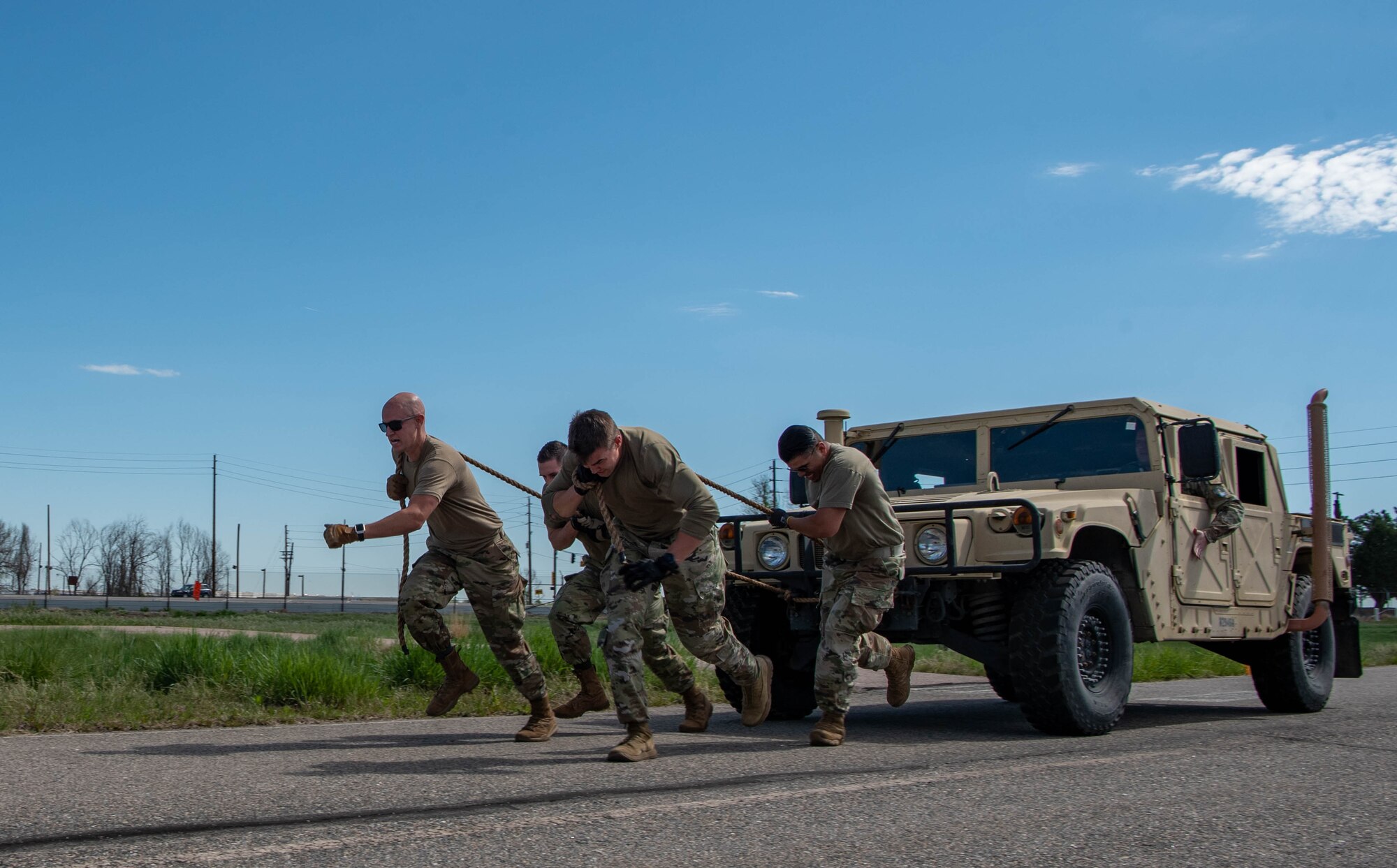 men pull a humvee with rope