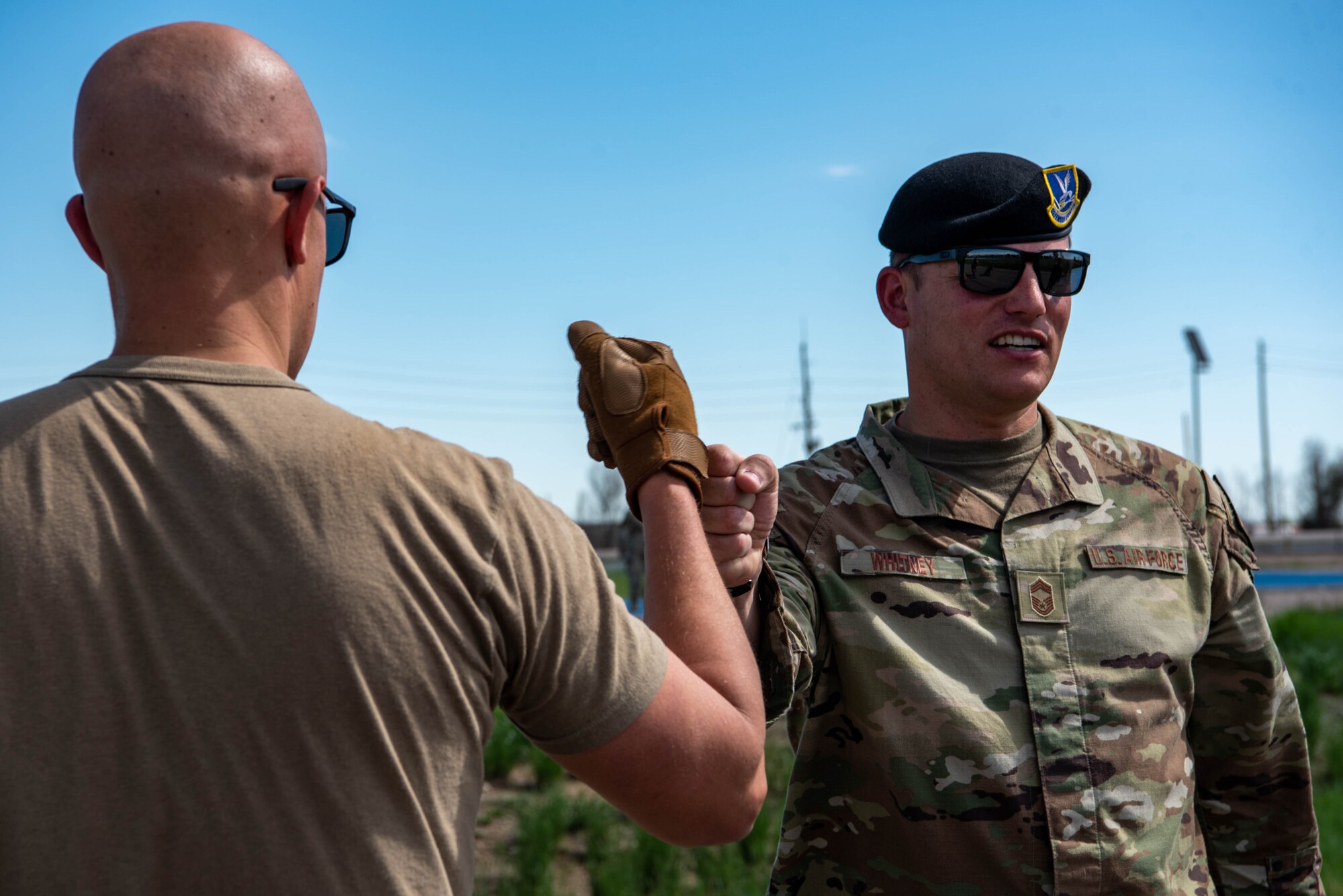 Two men fist bumping