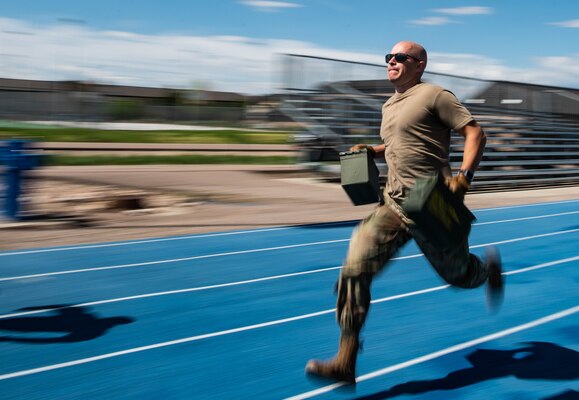 Guy runs with ammo cans