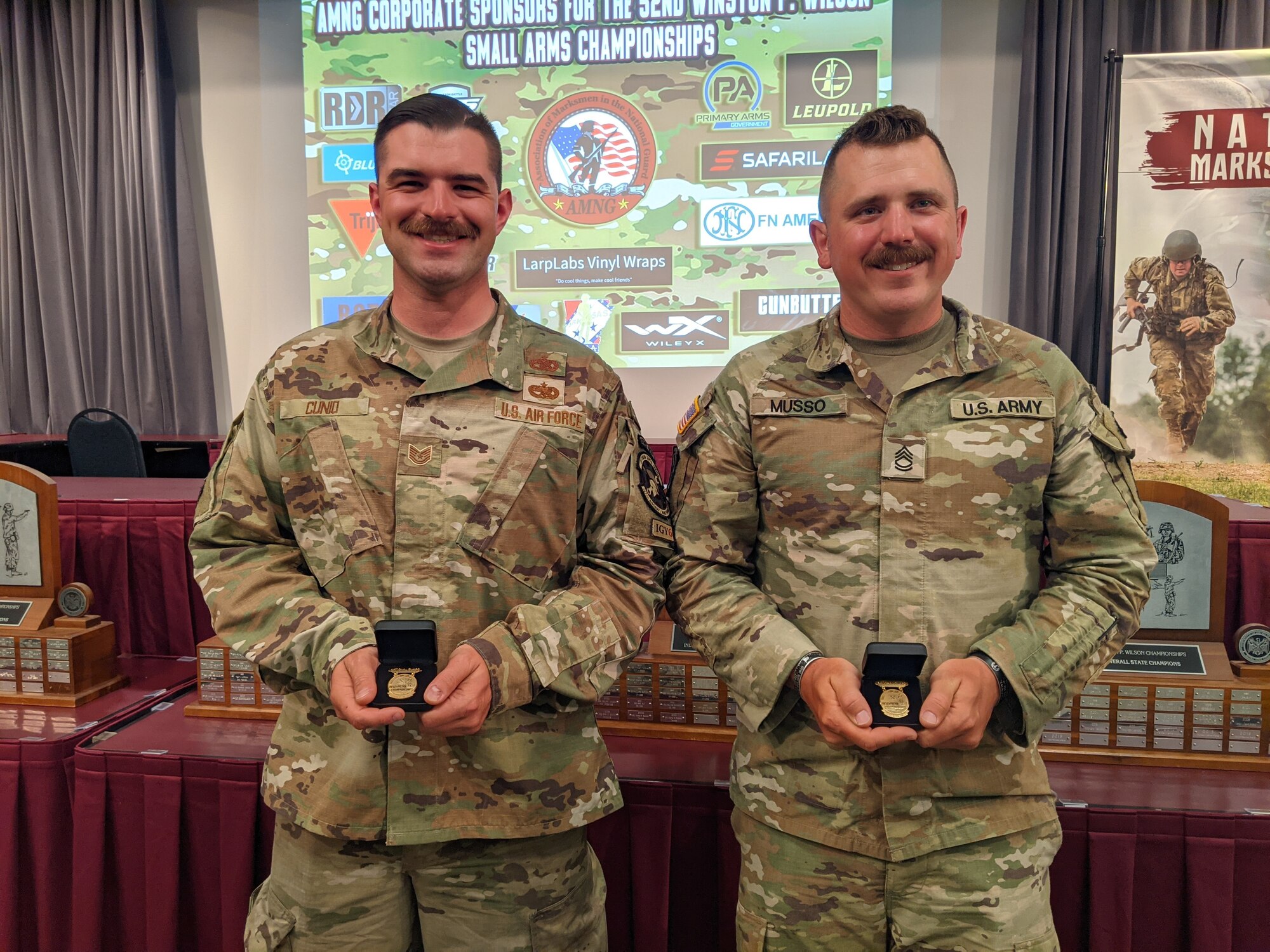 Two NHNG shooters, Tech. Sgt. Connor Cunio of the 157th Air Refueling Wing and Sgt. 1st Class David Musso of 3643d Brigade Support Battalion show off their “Chief’s 50” badges May 5, 2023, at the 52nd Annual Winston P. Wilson Rifle and Pistol Championships awards ceremony in North Little Rock, Arkansas.