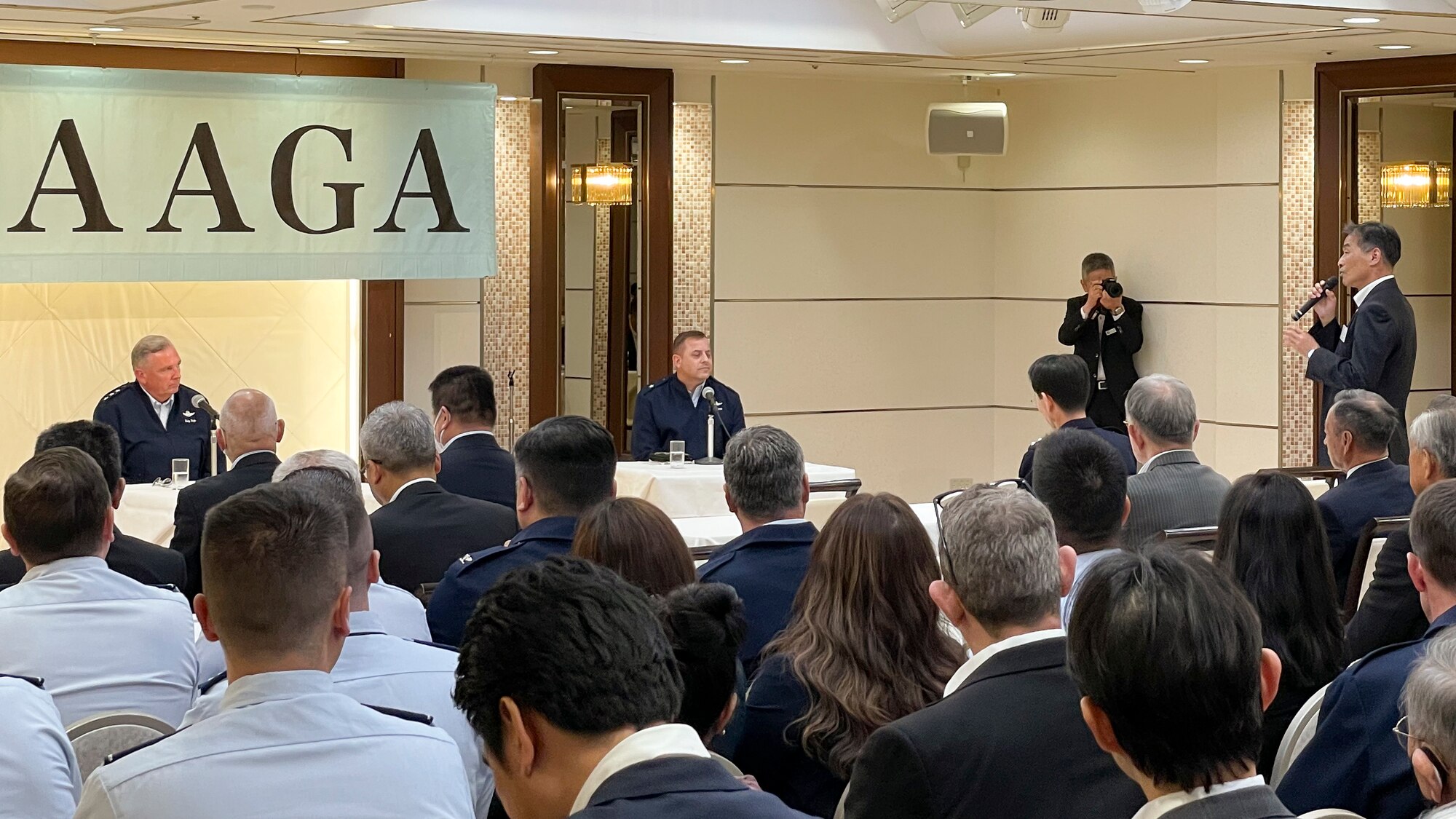 Two American men facing a crowd are asked a question from the audience