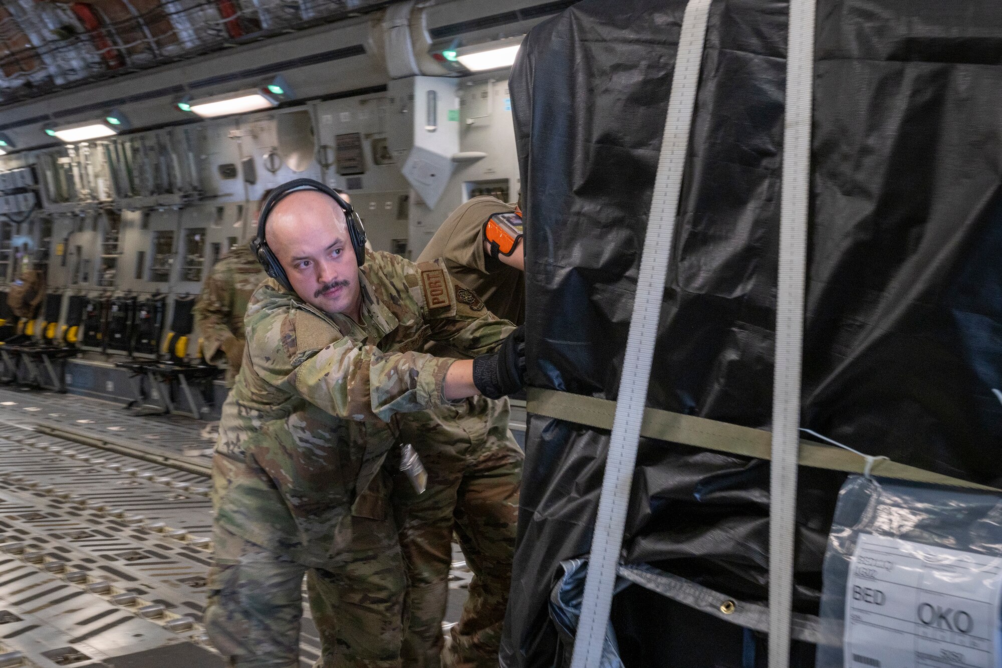 Airmen from the 730th Air Mobility Squadron offload a pallet from a C-17 Globemaster III assigned to the 436th Airlift Wing, Dover Air Force Base, DE, at Yokota Air Base, Japan, May 10, 2023.