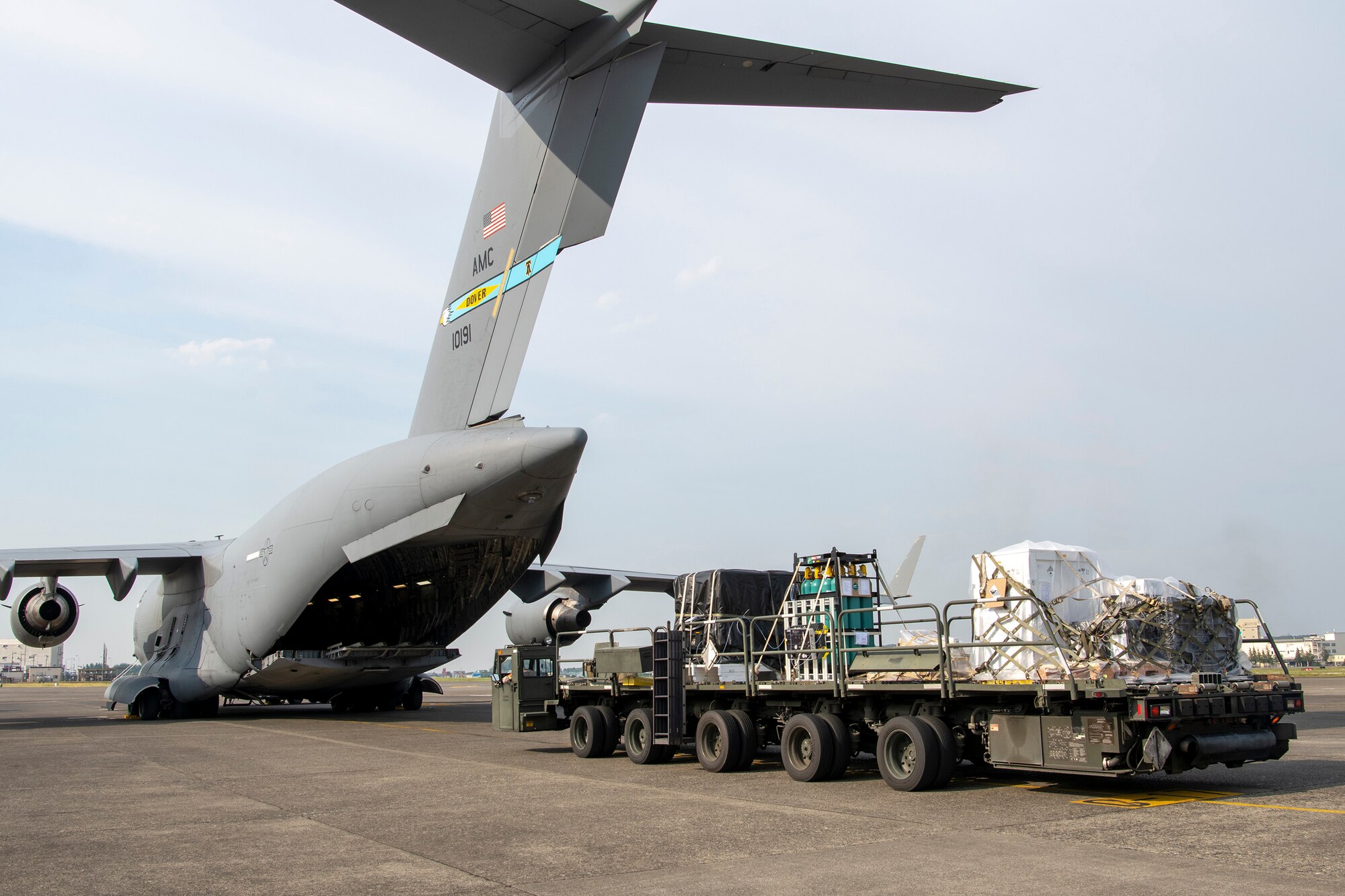 Members of the 730th Air Mobility Squadron offload satellite payload pallets from a C-17 Globemaster III assigned to the 436th Airlift Wing, Dover Air Force Base, Del., May 10, 2023.