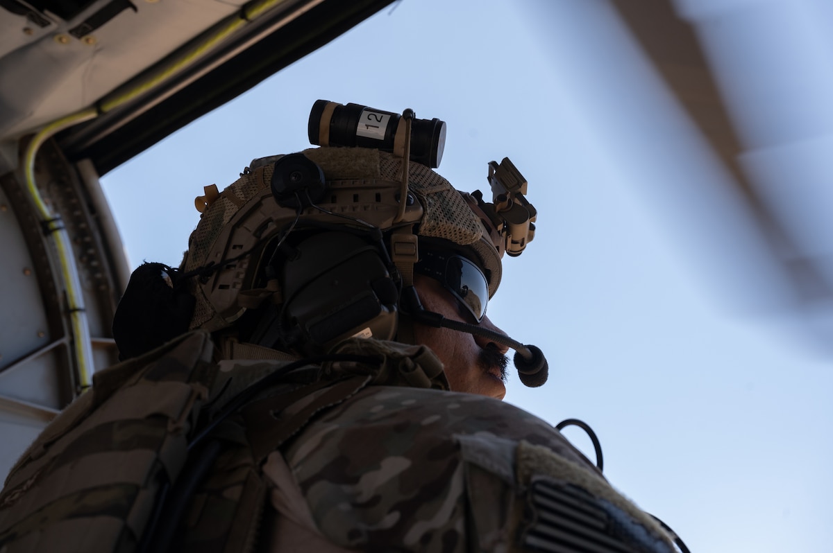 U.S. Air Force Tech Sgt. Jorge Avila, 48th Rescue Squadron pararescue team leader, looks out of the door of a HH-60W Jolly Green II helicopter over Arizona, May 13, 2023. The 48th Rescue Squadron trains, equips and employs combat-ready pararescuemen, combat rescue officers and supporting personnel worldwide in support of U.S. national security interests. (U.S. Air Force photo by Airman 1st Class Jasmyne Bridgers-Matos)
