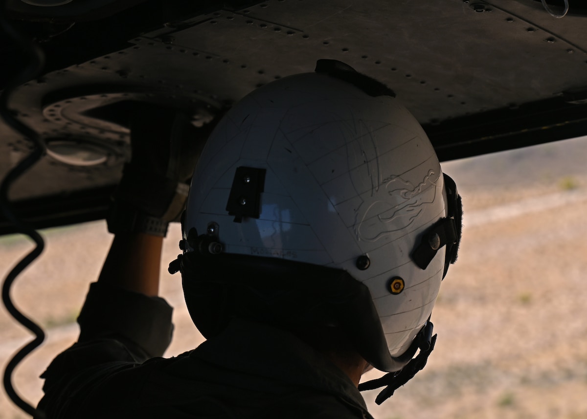 U.S. Marine Corps Lance Cpl. Elijah Morales, Marine Light Attack Helicopter Squadron 775 crew chief, searches for mock enemies on the ground during Exercise RED FLAG-Rescue 23-1 over various places in Arizona and New Mexico, May 13, 2023. Morales enhanced situational awareness for the UH-1Y Venom utility helicopter pilots. (U.S. Air Force photo by Staff Sgt. Abbey Rieves)