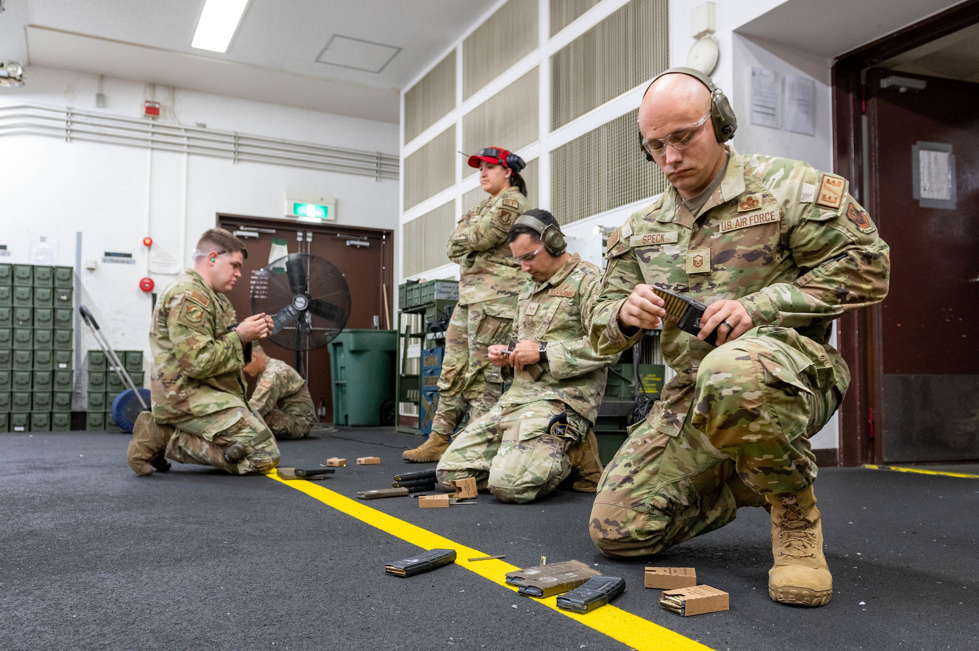 Airmen load their magazines before a marksmanship competition in honor of Police Week.