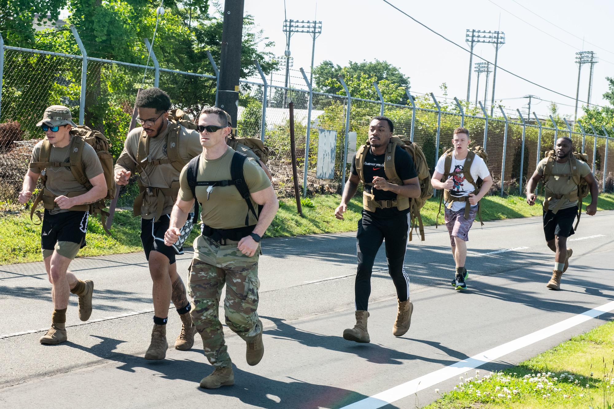 Military members participate in a ruck march.