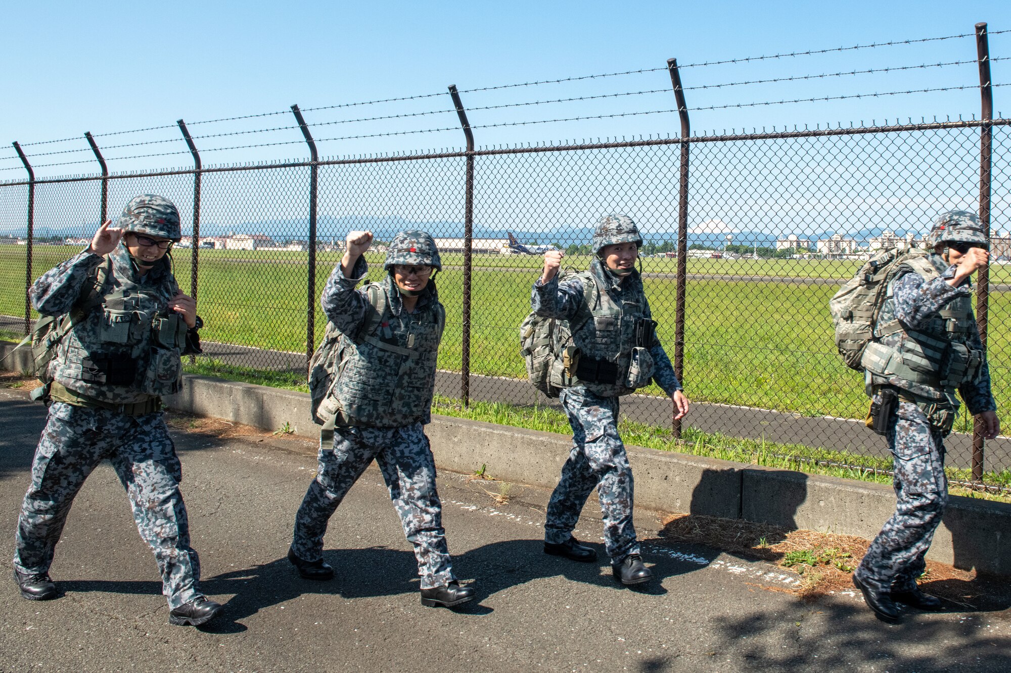 Japanese military members participate in a ruck march.