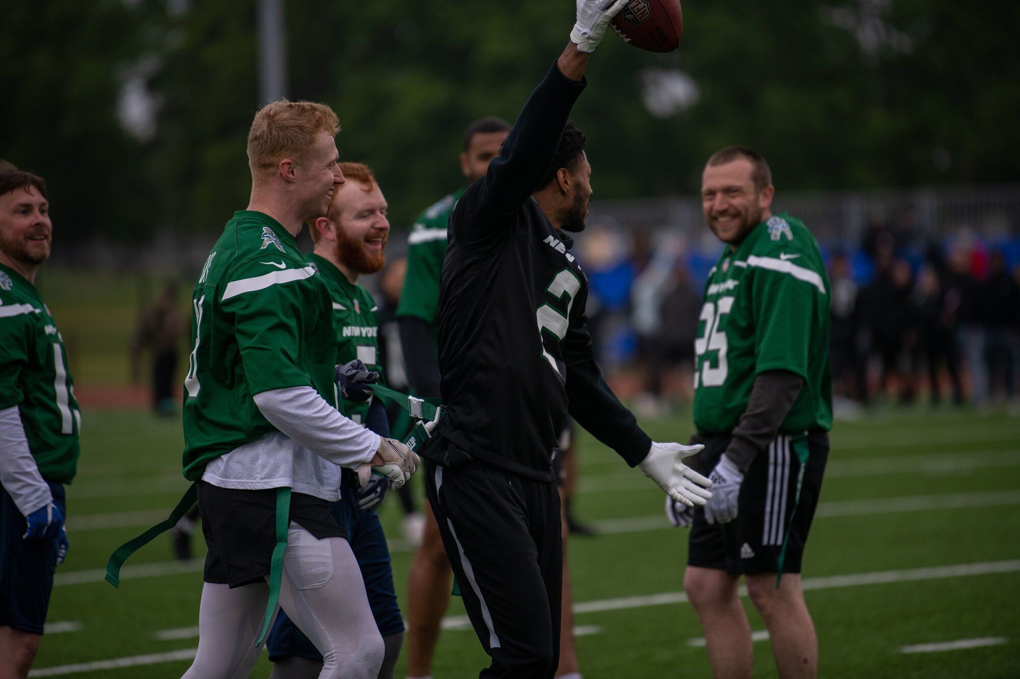 U.K. Armed Forces team members down U.S. Air Force Airman 1st Class Cody Alfred, 748th Aircraft Maintenance Squadron assistant dedicated crew chief, during a flag football game at Royal Air Force Lakenheath, England, May 12, 2023. The matches provided an opportunity for the Partner nations to participate in a friendly, military-to-military engagement and build relationships with one another. (U.S. Air Force photo by Airman 1st Class Renee Nicole F. Gamez)