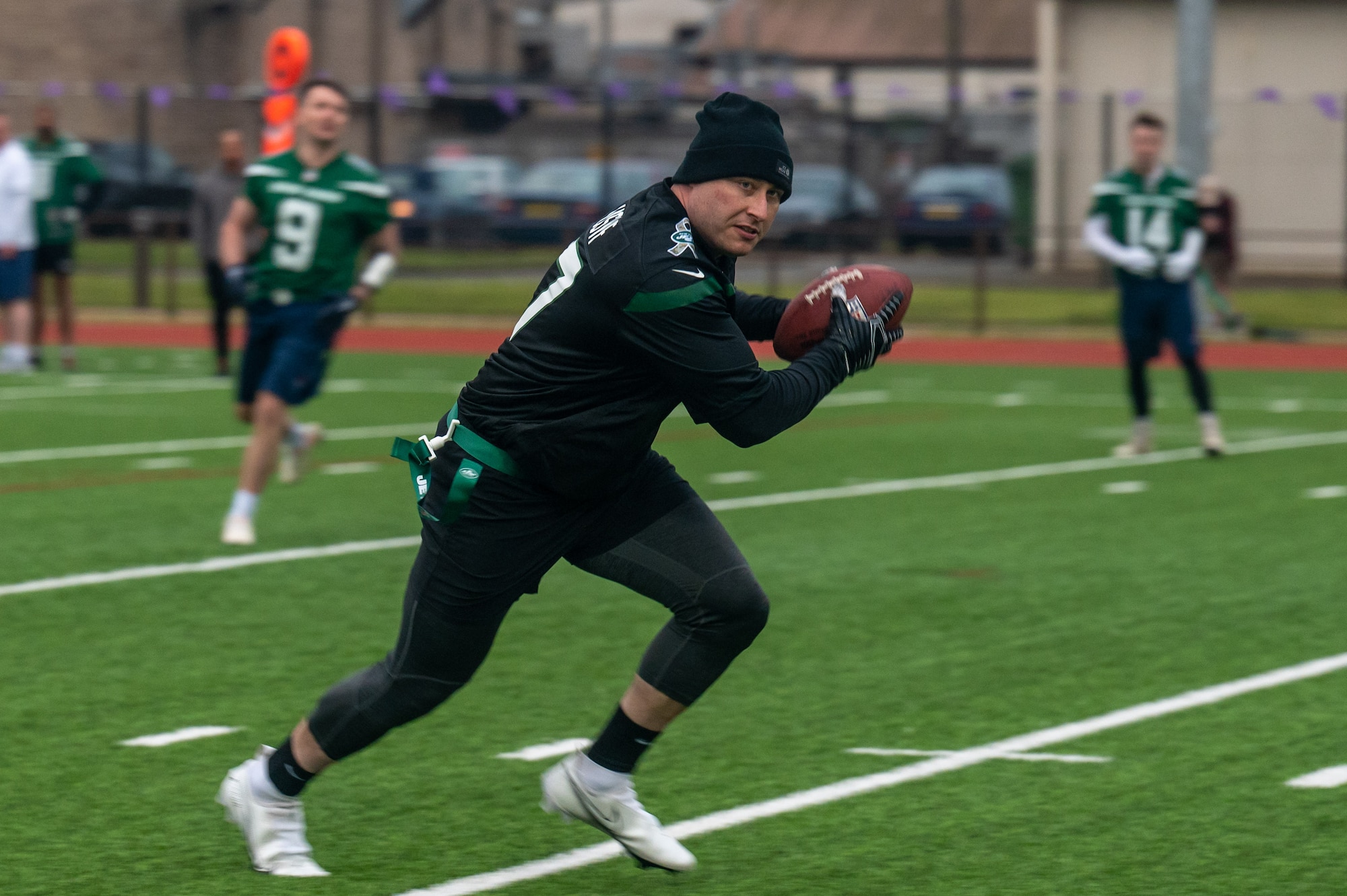 U.S. Air Force Staff Sgt. Robert Briske, 752nd Special Operations Aircraft Maintenance Squadron phase avionics technician, runs toward the end zone during a flag football game against a U.K. Armed Forces team at Royal Air Force Lakenheath, England, May 12, 2023. The game was intended to foster positive relations between the two partner nations through an exchange of a cultural pastime. (U.S. Air Force photo by Airman 1st Class Seleena Muhammad-Ali)